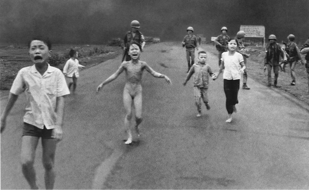 TRANG BANG:South Vietnamese forces follow after terrified children, including 9-year-old Kim Phuc, center, as they run down Route 1 near Trang Bang after an aerial nap