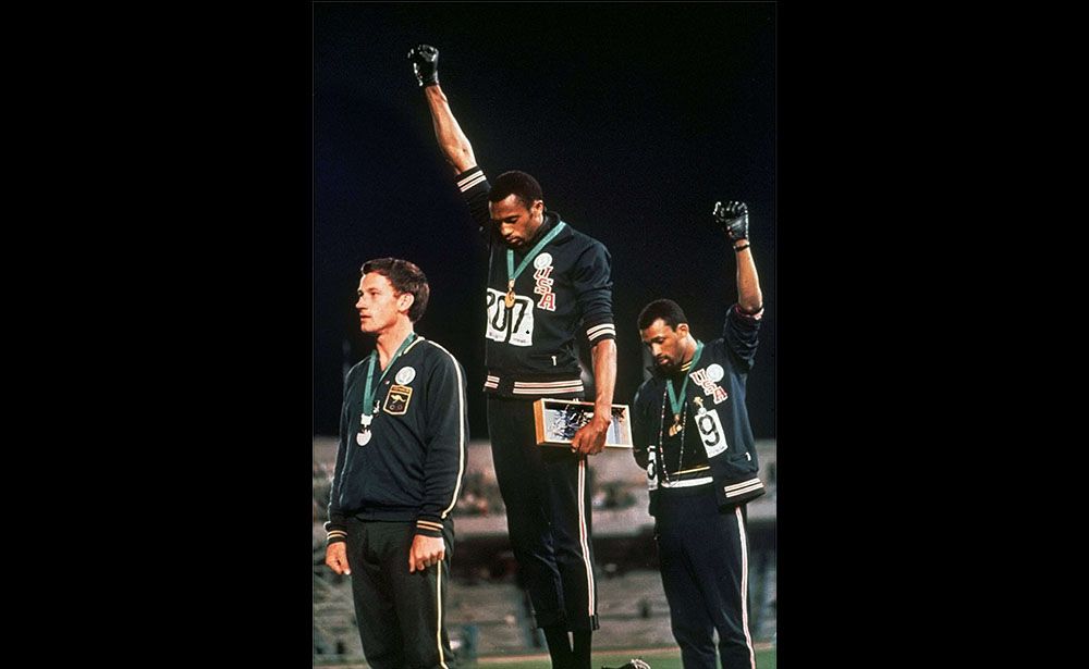 FILE - In this Oct. 16, 1968, file photo, U.S. athletes Tommie Smith, center, and John Carlos stare downward while gesturing skyward during the playing of the Star Spangled Banner after Smith received the gold and Carlos the bronze for the 200 meter run at the Summer Olympic Games in Mexico City. Australian silver medalist Peter Norman is at left. Time will tell whether the ``hands-up'' gesture that five St. Louis Rams made during pregame introductions on Sunday, Nov. 30, 2014, will leave a lasting memory or simply go down as a come-and-go moment in the age of the 24-hour news cycle. Either way, it certainly isn't the first time high-profile athletes have used their platform to make political statements. (AP Photo/File)/NY158/334429209070/OCT. 16, 1968 FILE PHOTO/1412012222