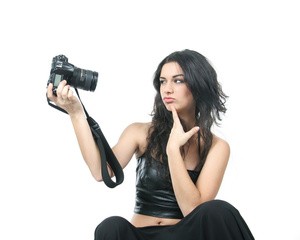 studio shot of young beautiful woman making self-portrait over white