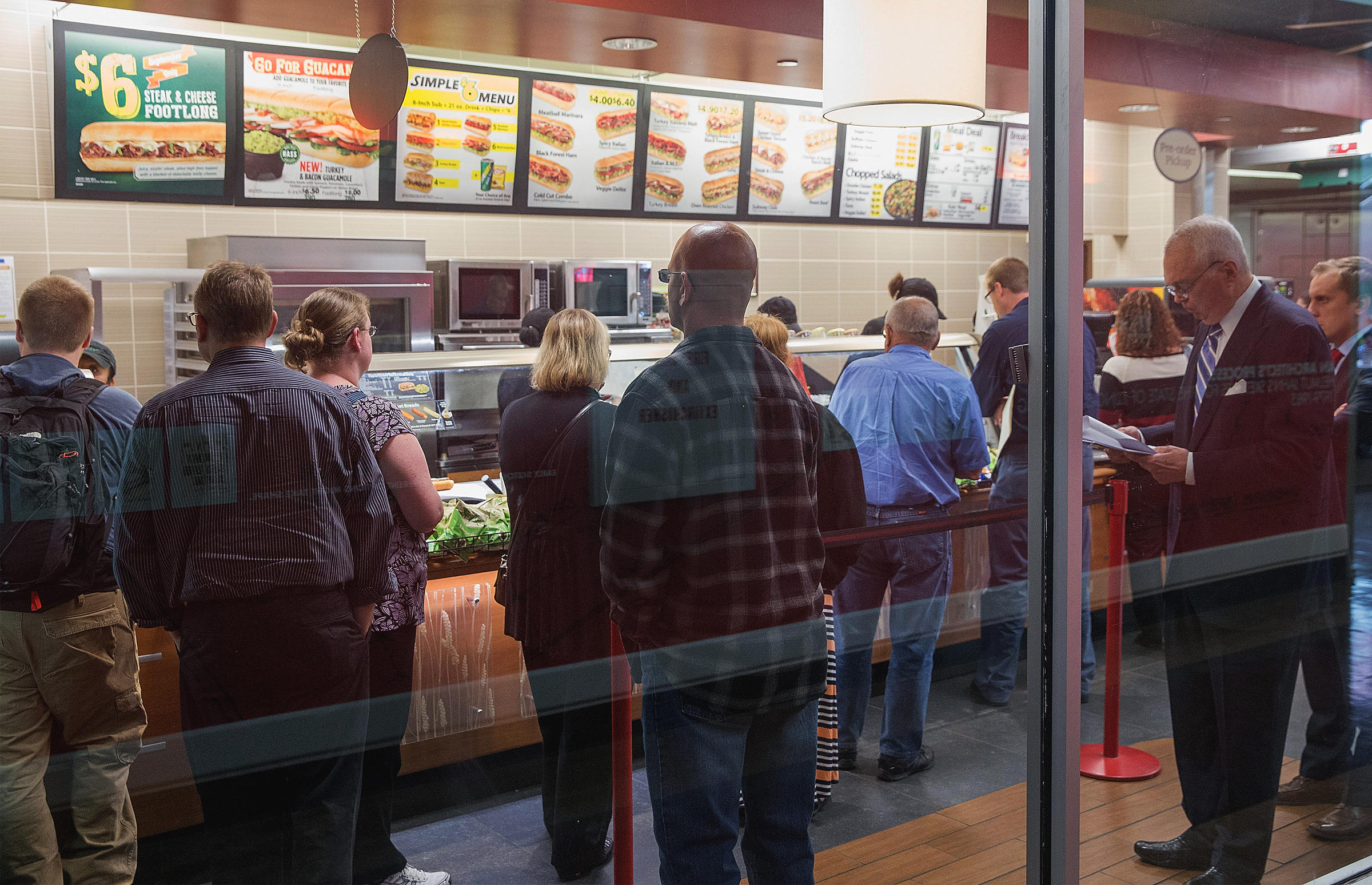 Diners wait in line at a Subway sandwich shop on September 15, 2015 in Chicago, Ill. Subway will serve antibiotic-free turkey and chicken by the end of 2016, but it may take nine years for its suppliers of beef and pork to go antibiotic-free as well